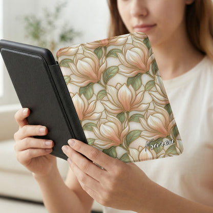 Woman holds e-reader with floral magnolia case signed "Karen".